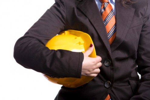 Woman engineer or architect with yellow safety hat